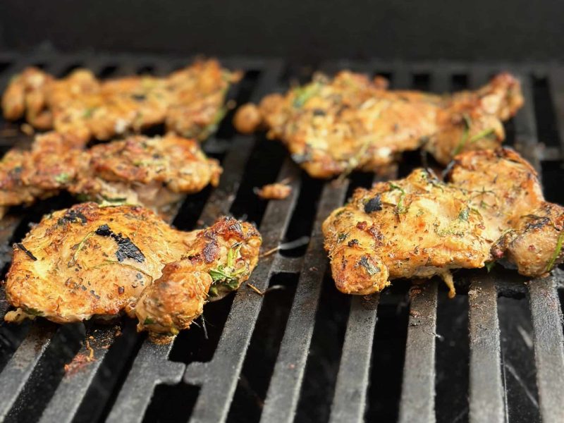 chicken thighs seasoned with latin heat on the grill