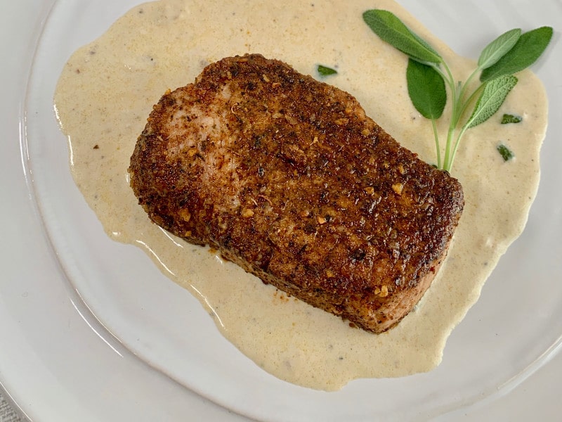 plate of pork chop sage cream sauce