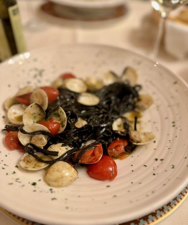 Pasta with quid inks, clams and tomatoes