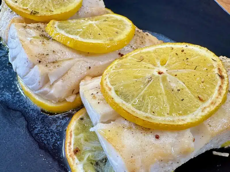 Fish With Lemon on a black plate